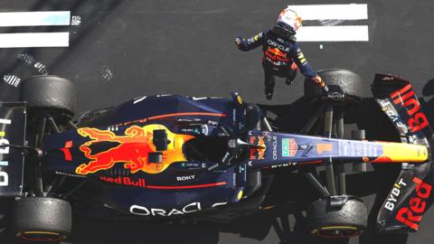 Max Verstappen leaps out of his Red Bull after winning the Hungarian Grand Prix