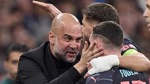 Manchester City's Phil Foden celebrates with manager Pep Guardiola after scoring against Real Madrid in their Champions League quarter-final first leg