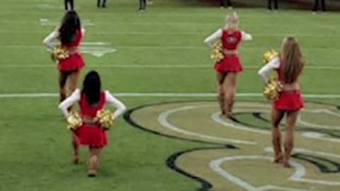 Cheerleader kneels
