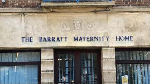 Stone building with "The Barratt Maternity Home" above the door