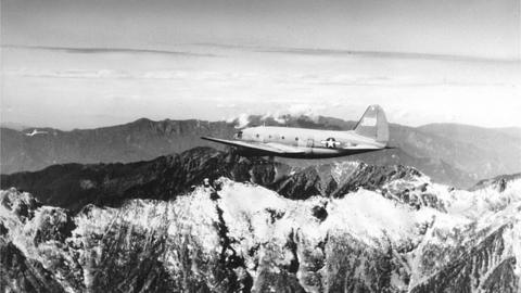 View of a US Army Air Transport Command cargo plane as it flies over the snow-capped, towering mountains of the Himalayas, along the borders of India, China, and Burma, January 1945, February 20, 1945.