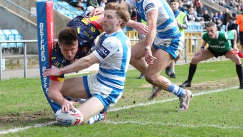Catalans Dragons winger Tom Davies scoring a try