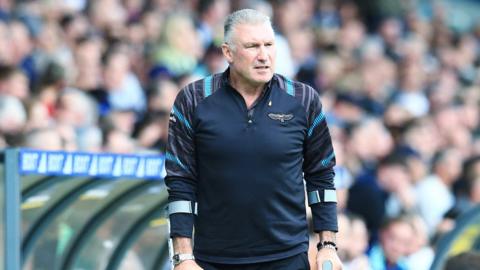 Nigel Pearson walking on crutches on the edge of the pitch at Elland Road during Bristol City's game against Leeds in October