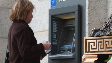 A woman at an ATM in the US