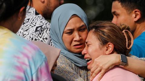 Family and relatives react at the scene of light aircraft crash in Elmina, state of Selangor, Malaysia, 17 August 2023.