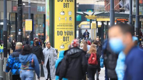 A social distancing advice sign in Manchester city centre