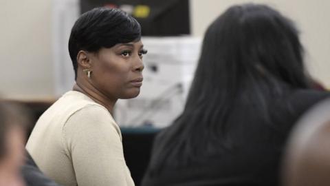 Crystal Mason, middle, convicted for illegal voting and sentenced to five years in prison, sitting at the defense table at Tim Curry Justice Center in Fort Worth, Texas, on May 25, 2018.