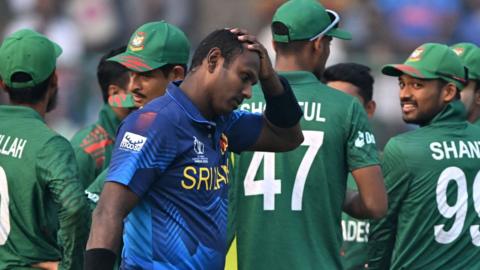 Bangladesh players celebrate after Sri Lanka's Angelo Mathews is given out timed out
