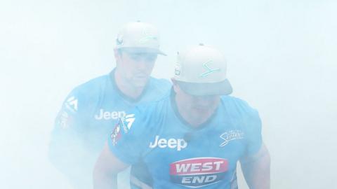 Travis Head and Brad Hodge of the Adelaide Strikers walks onto the field through smoke during the Big Bash League match between the Adelaide Strikers and the Sydney Sixers at Adelaide Oval on December 31, 2015 in Adelaide,