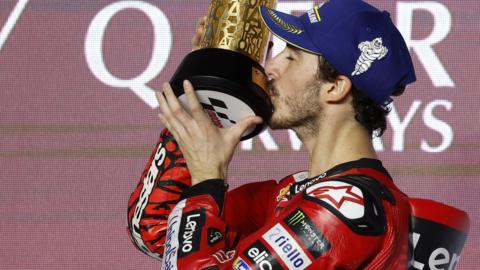 Francesco Bagnaia kisses the trophy after winning in Qatar