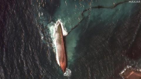 A satellite image shows a close-up view of a capsized barge and an oil spill, off the shore of Tobago Island, Trinidad and Tobago, February 14, 2024.