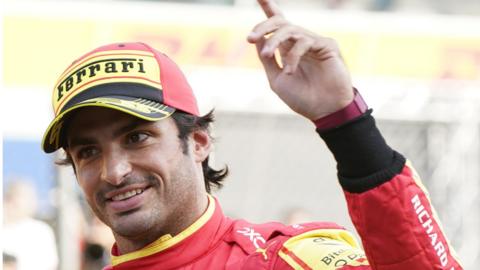 Carlos Sainz holds his index finger up to celebrate his pole position for the Italian Grand Prix at Monza