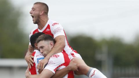 Hull KR’s Tanguy Zenon celebrates with teammates after scoring their sides second try against Salford in the Challenge Cup