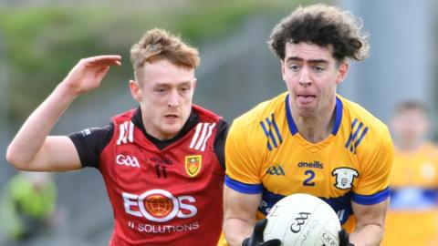 Down's Liam Kerr is about to get in a challenge on Clare's Manus Doherty