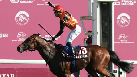 Cristian Demuro celebrates winning the Qatar Prix de l'Arc de Triomphe aboard Ace Impact