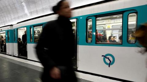 Passengers walk on a platform at Saint-Lazare metro station in Jan 2023