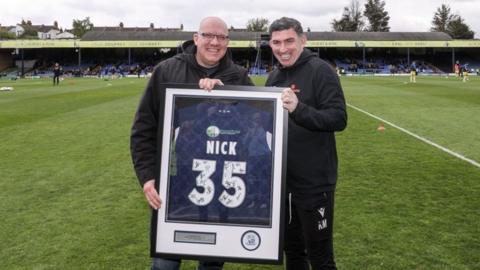 Nick Alliker is presented with a special shirt