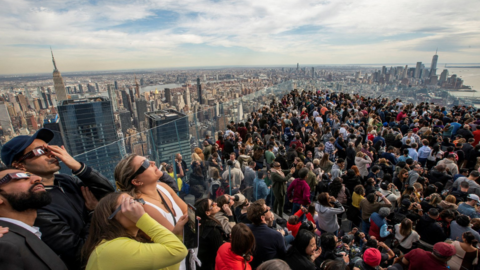 Hundreds watch the sky on the viewing platform of the Edge in New York