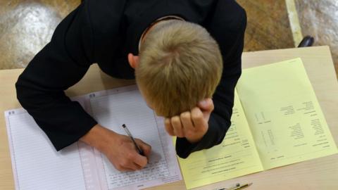 A student taking a GCSE exam