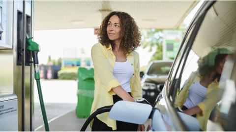 Woman filling car