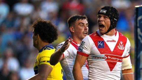 Jonny Lomax (right) celebrates having scored St Helens' third try against Warrington Wolves