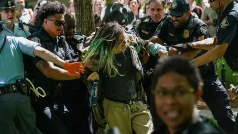 Police officers arrest a demonstrator during a pro-Palestinian protest against the war in Gaza at Emory University in Atlanta, Georgia, on 25 April 2024