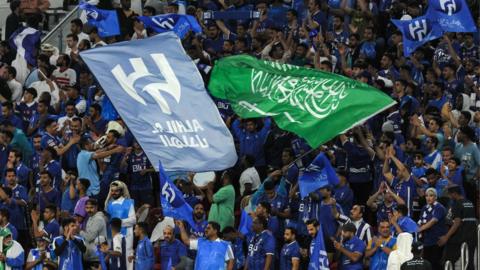 Al-Hilal's fans wave their team's and Saudi Arabia's flag