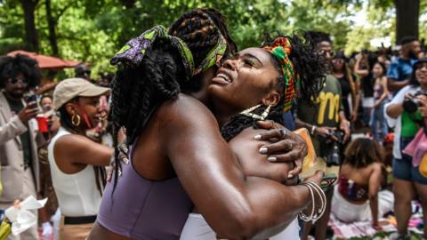 Two people hug during a Juneteenth celebration in Fort Greene park on 18 June 2023 in the Brooklyn borough of New York City, US