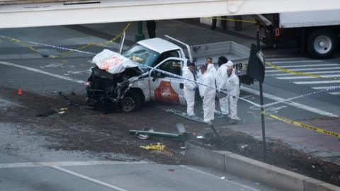 Investigators inspect a truck following a shooting incident in New York on October 31, 2017