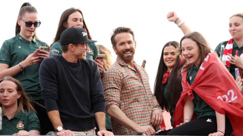 Rob McElhenney and Ryan Reynolds with Wrexham Women's team on athe 2023 bus parade