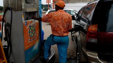 An attendant dispenses fuel into a vehicle's tank at a fuel station in the Maryland district of Lagos, on September 8, 2020