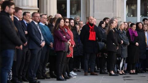 People observe a minute's silence during a service to commemorate the 35th anniversary of the Hillsborough Disaster at Exchange Flags in Liverpool