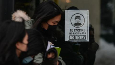 Sign 'No Vaccine, No Mask, No Entry' seen on the door of a store on Whyte Avenue in Edmonton. Monday, December 13, 2021, in Edmonton, Alberta, Canada