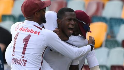 Shamar Joseph celebrates the winning wicket