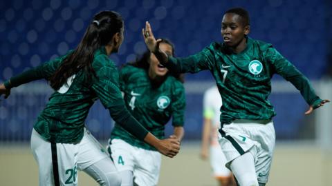 Saudi Arabia's Nora Ibrahim (R) celebrates her goal during a friendly football match between Saudi Arabia and Bhutan