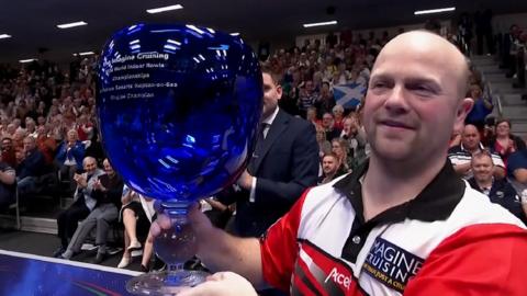 Stewart Anderson lifts the World Indoor Bowls trophy