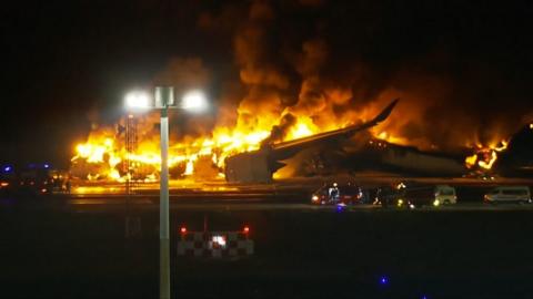 Plane engulfed by flames on runway