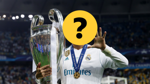 Footballer with face covered holding the Champions League trophy