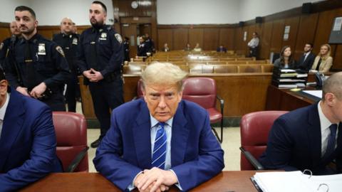 Donald Trump seated in a New York City courtroom