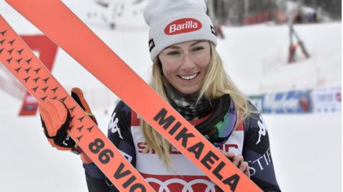 Mikaela Shiffrin with skis with her name and 86 victories written across them