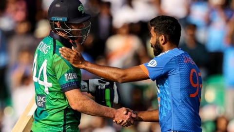 Craig Young shakes hands with Jasprit Bumrah