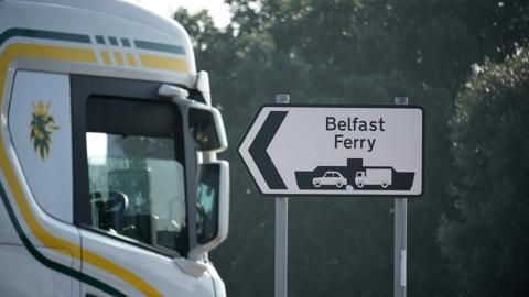 A lorry passes a sign in Liverpool for the ferry to Belfast