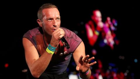 Chris Martin of Coldplay performs on stage at Optus Stadium in Perth, Australia