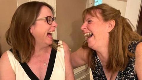 Cathie (left) and Tricia laughing at a party