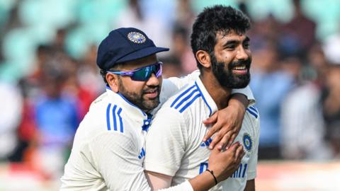 India captain Rohit Sharma (left) embraces bowler Jasprit Bumrah (right) after a wicket