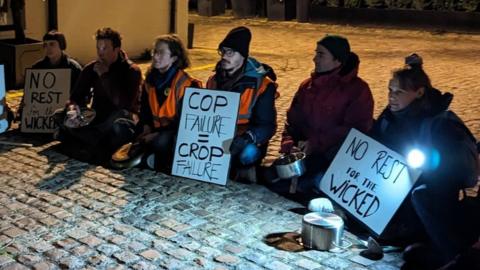 Protesters sit on the floor outside Sunak's home