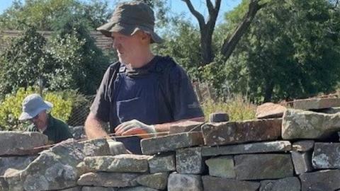 Paul Foster building a dry stone wall
