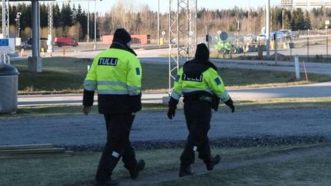 Custom officials walk near the Nuijamaa border crossing station between Finland and Russia, in Lappeenranta, southeastern Finland on November 17, 2023, after the Finnish government announced to close four of its eight eastern border crossings with Russia early on November 18.