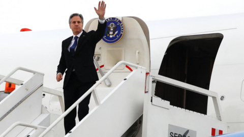 Antony Blinken waves from the plane as he departs at Felipe Angeles International Airport in Zumpango, Mexico