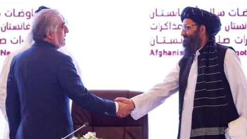 Handshake between Taliban co-founder and US representative in Doha 2020